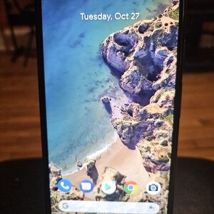 Sleek Black Smartphone with Coastal Display